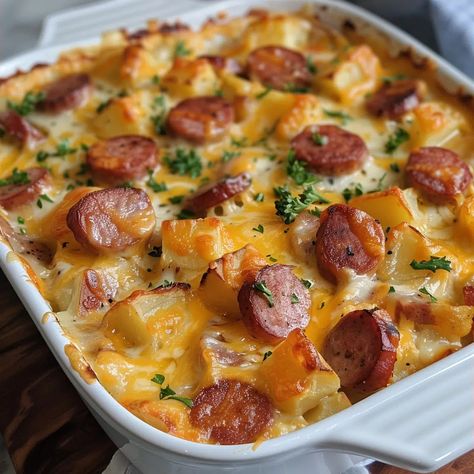 Easy Cheesy Potato & Smoked Sausage Casserole Recipe - emiliarecipes.com Cheesy Smoked Sausage And Potatoes, Smoked Sausage And Hashbrown Casserole, Sausage And Cheesy Potatoes, Cheesy Potatoes And Sausage, Cheesy Sausage And Potatoes, Potato Smoked Sausage Casserole, Smoked Sausage And Potatoes, Sausage And Potato Casserole, Smoked Sausage And Potato Recipe