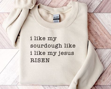 Just the shirt for any person who loves sourdough and Jesus! ▸ Gildan 18000 Sweatshirt ▸ 55% cotton/45% polyester ▸ Unisex Adult Sizing  ▸ Props used In photos are NOT included with purchase  WASHING INSTRUCTIONS ▸ Wash inside out, in cold water, on gentle cycle. Tumble dry low or let air dry  ▸ Do not use Fabric Softeners or Bleach ▸ Do not dry clean. Avoid ironing on the design.  SIZE ▸ Take a look at the photos to see a specific sizing chart for this sweatshirt style ▸ Please note that these shirts are unisex size meaning they are not women's fitted shirts.  ▸ Lay your favorite shirt at home flat and measure armpit to armpit to compare to the size chart in the photos RETURNS OR EXCHANGES ▸ All of our shirts are custom printed just for you so we do not accept returns or exchanges due to Sourdough Shirt, Funny Baking Shirts, Crunchy Mama, Baker Shirts, Christian Shirts Designs, Christian Merch, Fitted Shirts, Cute Shirt Designs, Sweatshirt Style