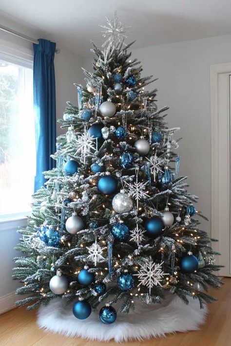 Snowflake Theme Tree, White Silver And Blue Christmas Decor, Fantasy Themed Christmas Tree, Winterwonder Land Christmas Tree, White Silver And Blue Christmas Tree, Snow Theme Christmas Tree, Christmas Decorations Blue And Silver, Dining Room Decor For Christmas, Snow Themed Christmas Decor