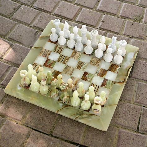 Indulge in the game of Kings with beautifully handcrafted marble Chess set. The completely handmade chess board features uniquely style chess pieces in vibrant colours. The marble is cut, shaped and polished to give this chess set the shiny look as pictured. Size: 40 cm x 40 cm (15 inches x 15 inches) Make Every Move With Style! The weighted chess pieces are soft to touch and easy to move. The sturdy composition of marble makes sure that no matter how many times the pieces get thrown around on t Large Chess Set, Gifts For Him Christmas, Gifts For Housewarming, Luxury Chess Sets, Marble Chess Set, Hus Inspiration, Chess Pieces, Chess Set, Dream House Decor