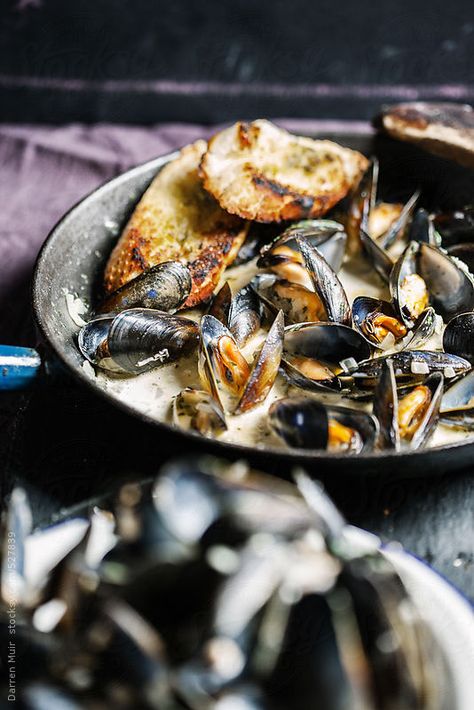 Cooked mussels in a creamy garlic and white wine sauce. by Darren Muir. Moules mariniere. Available to licence on stocksy. quote DARRENMUIR20 on checkout for 20% discount. Mussels Photography, Chef Ideas, Food Net, White Wine Sauce, Seafood Pasta, Wine Sauce, Creamy Garlic, Sea Food, Iron Pan