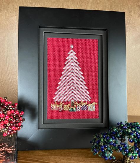 A Silver Christmas - A simple little Christmas tree in cross stitch and straight stitches with beads. The presents underneath are done in specialty stitches with odds and ends of metallic thread, with bows on top. You can stitch this lovely tree on either 18 count mono canvas or on 28 count linen with 10 threads and one type of beads. Instructions are included for both. Stitch count is 46 x 79 with a finished size of approximately 3.5” x 5.5”. Both versions fit nicely into a 4” x 6” matted ... Little Christmas Tree, Cross Christmas Tree, Cross Stitch Tree, Little Christmas Trees, Odds And Ends, Silver Christmas, Straight Stitch, Canvas Designs, Metallic Thread