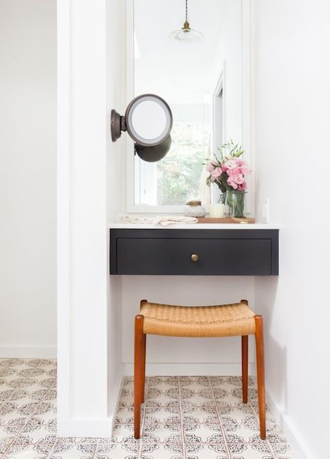 Gorgeous vanity nook features a black floating dressing table with white mirror above, and wall mount make-up mirror to the right, over a mid-century modern teak vanity stool atop hand painted terracotta floor tiles. Amber Interiors Bathroom, Vanity Nook, Bathroom With Makeup Vanity, Desks For Small Spaces, Bright Homes, Room Deco, Amber Interiors, Small Desk, Hus Inspiration