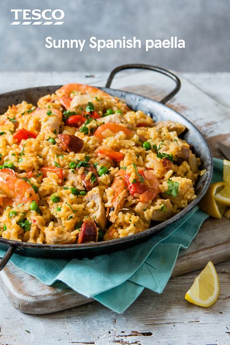 Cook up some Spanish sunshine with our classic paella recipe. Packed with chorizo, chicken, prawns and veg, this simple recipe gets it's vibrant colour from sweet saffron and smoky paprika. | Tesco Chorizo Chicken, Spanish Paella Recipe, Easy Paella, Paella Recipe Seafood, Spanish Paella, Seafood Paella, Paella Recipe, Tesco Real Food, Spanish Dishes