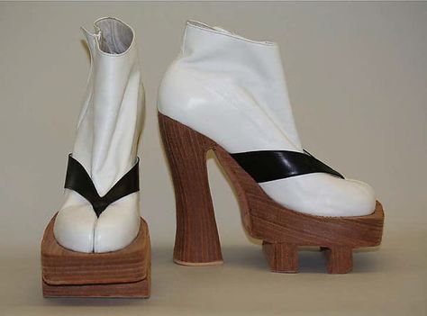 Byron Lars blended aspects of a 1970s platform shoe and a Japanese workman's clog. His white leather boot with black leather trompe-l'oeil strap approximates the tabi, the traditional Japanese woven bifurcated-toe sock, and the geta strap Japanese Heels Traditional, Japanese Shoes Traditional, Geta Shoes, Japanese Shoes, Byron Lars, White Leather Boots, Tabi Socks, Shoe Designs, Platform Shoe