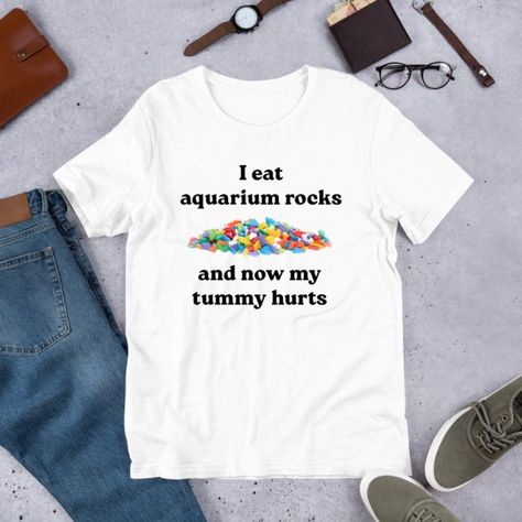 I Eat Aquarium Rocks, Funny Meme Shirt, Ironic Shirt, Oddly Specific Shirt Discover Our Latest Collection Of Versatile And Stylish T-Shirts (Gildan 5000), Where Fashion Meets Ultimate Comfort! Offered In Sizes Ranging From S To 3xl And A Vibrant Spectrum Of Colors Including Black, White, Sand, Green, Sport Grey, Red, Navy, And More, There's An Option To Cater To Every Taste. Crafted With Expertise Using Premium Materials, Our T-Shirts Provide A Luxurious Sensation And An Impeccable Fit That Last Unhinged T Shirts, Brynlee Core, Cursed T Shirts, Oddly Specific Shirts, Goofy Clothes, Obese Fashion, Ironic Tshirt, Goofy Shirts, Cursed Shirts