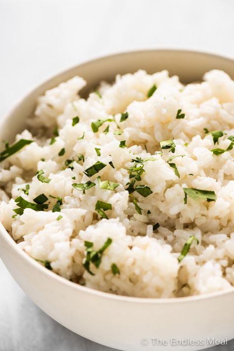 PIN TO SAVE! Coconut rice is so easy to make and the perfect side dish to all your Asian-influenced recipes. This recipe is a sugar-free version of your favorite Thai restaurant rice. #theendlessmeal #coconutrice #rice #coconut #thaicoconutrice #thairice #thai #coconutmilkrice #jasminerice #sugarfree #sidedish #vegan #vegetarian #glutenfree #grains #ricerecipe Thai Cuisine Recipes, Chipotle Cilantro Lime Rice, Thai Coconut Rice, Garlic Ginger Chicken, Mango Chicken Curry, Pineapple Pork Chops, Easy Risotto, Risotto Recipes Easy, Copycat Chipotle