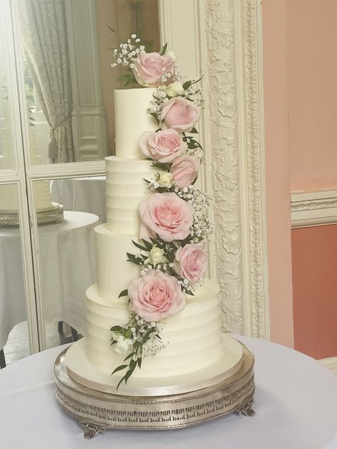 4 tier buttercream frosted cake in the ever popular Nature's Charm wedding cake with a cascade of fresh roses, ruscus and gypsophilia Cake Designs Buttercream, 4 Tier Cake, Frosted Cake, Wedding Cake Fresh Flowers, Buttercream Roses, Buttercream Wedding Cake, Wedding Cakes With Flowers, Wedding Cake Inspiration, Wedding Cake Designs