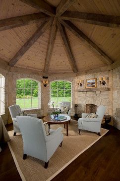 Octagonal living room with beige stone walls, tan seagrass rug and wooden ceiling, and aqua chairs - Peninsula Architects - www.pa-architects.com/selected-projects/bath-residence/ Shelves Minimalist, Traditional Family Room, Interior Design Minimalist, Rustic Porch, Hearth Room, Room Shelves, Minimalist House Design, Bath Room, Wood Interiors