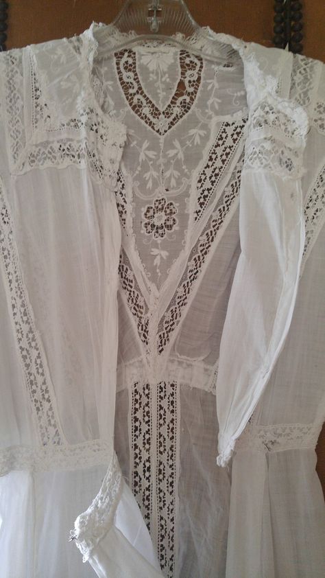 "1920's white cotton maxi floor length lawn dress. So beautiful!! Delicate panels of crochet lace detail. Small round neck with little stand up lace collar. The front of chest is heavily embroidered with flowers and panels of crochet and lace going down to a V to the drawn in waist which has its own crochet panel going around. The skirt flares out very slightly from the waist. It has vertical panels of crochet and horizontal ones at the top of hem. The hem is heavy white cotton doubled up (rest Lace Insertion Dress, Gilded Era, Sheer White Dress, White Sheer Dress, Crochet Panel, Edwardian Dress, Lawn Dress, Garden Party Dress, Irish Lace Crochet