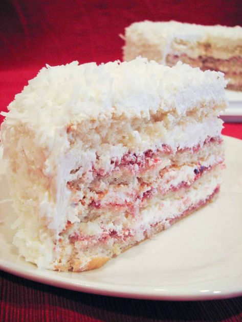 The perfect party cake, this lightly lemon cake is layered with raspberry preserves and a smooth, velvety buttercream frosting and then covered in sweetened coconut. #recipe #party #cake Zinger Cake, Raspberry Zinger Cake, Raspberry Zinger, Raspberry Coconut, Raspberry Preserves, Raspberry Recipes, Berry Cake, Cake Tasting, Pound Cake Recipes