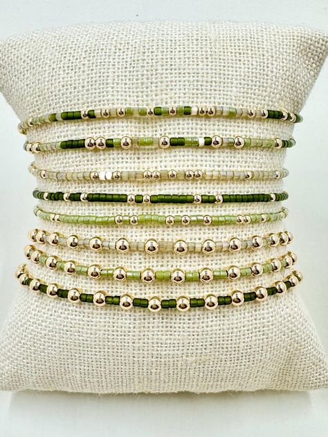 14K gold filled and shades of green miyuki seed bead stretch bracelets, perfect for fall and winter- dainty and minimalist in design, making it perfect for stacking and layering. REAL 14K Gold Filled Beads, will not tarnish- These bracelets are made with high quality gold filled beads and gemstones, easy to wear and so comfortable you can sleep and shower in them. Minimalist design, great for stacking. Perfect gifts for her. 14K Gold Filled Beads in 2, 2.5 and 3mm.  Available sizes may vary: If you're interested in a size that is not listed, please feel free to request, additional fee may apply. Bracelets Cord: Made with a strong, stretchy cord to easily slip on to your wrist. To find your bracelet size measure all the way around your wrist with a flexible tape measure, order 1/2 inch larg Green Seed Bead Bracelets, Seed Bead Stretch Bracelets, Bead Bracelet Stack, Homemade Bracelets, Bracelet Stacks, Stacking Bracelets, Bracelets Diy, Jewelry Accessories Ideas, Fitness Bracelet