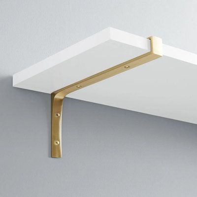 The rustic brass shelf bracket features a simple design that seamlessly works with a variety of different style projects. Signature Hardware Size: 4" H x 6" W x 0.88" D, Finish: Satin Brass | Signature Hardware Gehler Solid Brass Shelf Bracket in Satin Brass | 4" H x 6" W x 0.88" D | Wayfair Bracket Shelving, Gold Shelf Brackets, Brass Shelf Brackets, Brass Shelf, D Signature, Brass Shelves, White Shelves, Shelf Bracket, Hardware Finishes