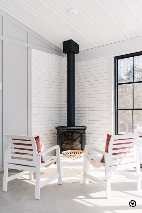 We made our wood stove a bit modern and a bit traditional by using a white brick surround. Adding some accessories to the hearth gives an even cozier vibe. This corner is the perfect spot to curl up in with these beautiful pillows adding that pop of color. It’s like being in your own cabin. A home away from home right off our kitchen. For this and other farmhouse living decor ideas follow me on the LIKEtoKNOWit app http://liketk.it/2GbmP #liketkit @liketoknow.it Wood Stove Decor, Wood Burning Stove Corner, Corner Wood Stove, Wood Stove Surround, Corner Stove, Stove Decor, Wood Stove Hearth, Wood Burning Stoves Living Room, Mini Wood Stove