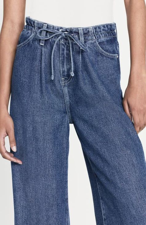 "Find FRAME Super Drape Wide Leg Denim Drawstring Pants on Editorialist. A less structured way to wear denim, these light and flowy pants keep you comfy with a drawstring waistband and full-length wide legs. 30\" inseam; 24\" leg opening; 12 1/2\" front rise; 15\" back rise (size 29) Elastic/drawstring waist Front scoop pockets; back patch pockets 100% lyocell Machine wash, dry flat Imported" Latest Jeans, Flowy Pants, Elastic Waist Pants, Wide Pants, Wide Legs, Wide Leg Denim, Drawstring Pants, Light Denim, Drawstring Waistband