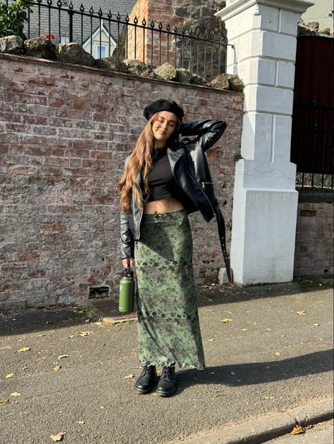 Floral green maxi skirt, black leather biker jacket, dr marten boots, black beret Maxi Skirt With Leather Jacket, Long Floral Skirt Outfit Winter, Green Floral Skirt Outfit, Maxi Skirt With Boots, Green Leather Skirt Outfit, Green Maxi Skirt Outfit, Baret Outfit, Floral Maxi Skirt Outfit, Flower Skirt Outfit