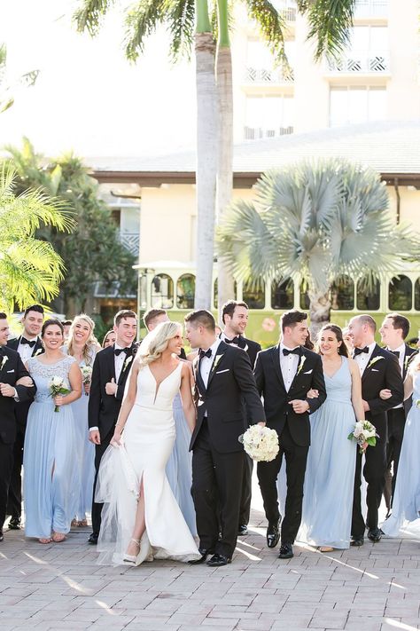 Black Suit And Light Blue Tie, Dusty Blue Wedding Black Suit, Blue Black Tie Wedding, Blue Wedding Theme Bridal Party, Black Suits Blue Dresses Wedding, Blue Black And Cream Wedding, Black Suit With Dusty Blue Tie, Dusty Blue And Black Wedding Party, Black Tie Wedding Blue Bridesmaids