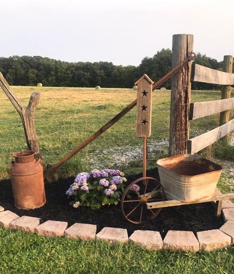 Antique Yard Decor, Antiques Repurposed Farmhouse, Flag Pole Landscaping Flower Beds, Country Farmhouse Garden Ideas, Dyi Landscaping Ideas On A Budget Flower Beds Front Yards, Mini Wheelbarrow Decor, Country Driveway Entrance Landscaping, Antique Yard Decor Ideas, Old Plow Yard Decor