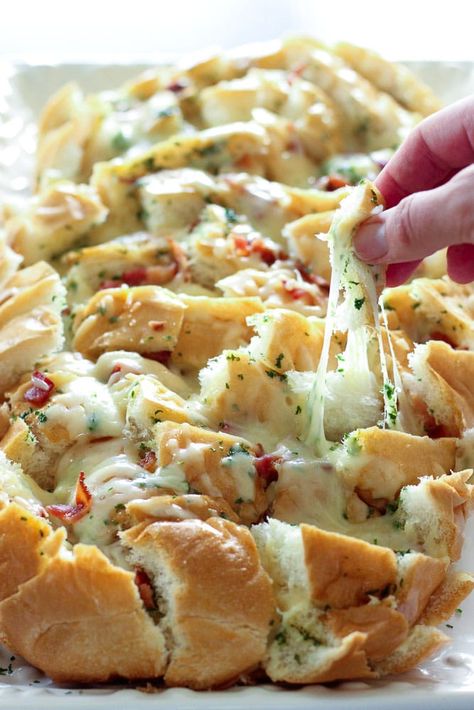 This Cheesy Bacon Garlic Pull Apart Bread is even more delicious than it sounds. Stuffed with smoky bacon, melted cheese and delicious garlic parsley butter, it's so irresistible everyone will beg you to make it again. Perfect for a party or a potluck. Bonus: it's super easy to make! #partyfood #potluckrecipes #gamedayrecipes Garlic Pull Apart Bread, Cheesy Pull Apart Bread, Cheesy Garlic Bread, Cream Cheese Dips, Cheesy Bacon, Pull Apart Bread, Bacon Cheese, Perfect Appetizers, Pull Apart