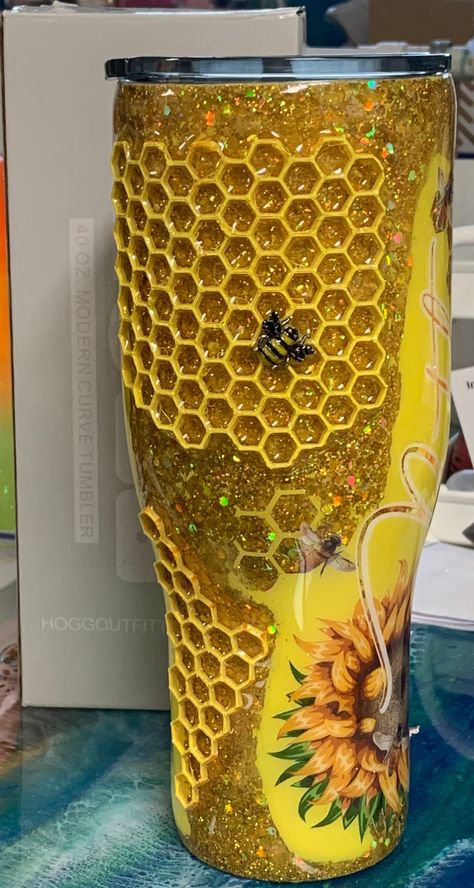 I just love this cup.  It is created using a base of holographic glitter which changes color in the lighting depending on how the light hits it the color shows flecks of gold and yellows.  The honeycomb is my view of the bees hard at work making honey and the lip of the cup shows the honeypot is overflowing. Option now available to choose from the standard Sunflower image or the 10 different Gnomes to decorate your honeybee tumbler.  Just choose when selecting your order. All of my cups offered Bee Snow Globe Tumbler, Bee Tumbler, Honeycomb Tumbler, Bee Epoxy Tumbler, Honeycomb Rhinestone Tumbler, Bumble Bee Nails, Bee Cup, Pineapple Tumbler, Sunflower Images