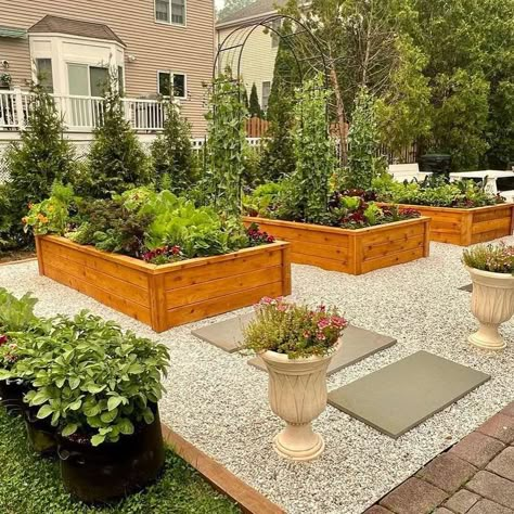 12 Raised Garden Bed Ideas We Love Raised Garden Bed With Fire Pit, Raised Flower Beds Backyard, Pea Gravel Garden Beds, Formal Raised Garden Beds, Raised Garden Beds Pea Gravel, Wooden Raised Garden Beds, Front Yard Raised Garden Beds, Stone Raised Garden Beds, Raised Bed Landscaping