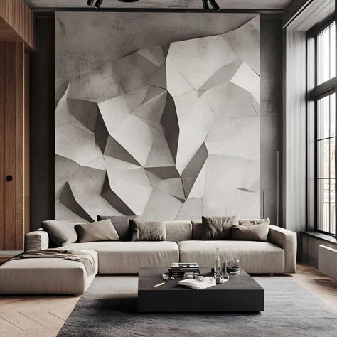 This sleek modern living room features a stunning geometric concrete accent wall with sharp, angular shapes, creating a bold, sculptural focal point. The minimalist design is complemented by a neutral-toned sectional sofa and a stylish black coffee table. Large windows flood the space with natural light, enhancing the industrial-chic aesthetic. Perfect for those seeking contemporary living spaces with unique concrete material building elements. Concrete Accent Wall, Compound Wall Designs, Textured Stone Wall, Art Wall Design, Minimalist Entryway, Rock Texture, Inspiring Lifestyle, Compound Wall Design, Stone Wall Design