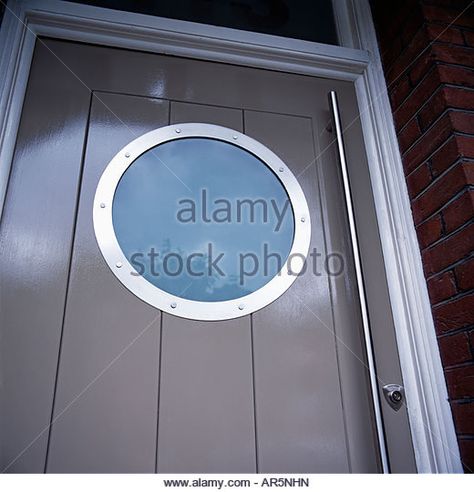 Close up of circular porthole window in modern grey front door - Stock Image Beige Front Door, Grey Front Door, Timber Front Door, External Front Doors, Modern Doors, Porthole Window, Round Window, External Doors, Modern Door