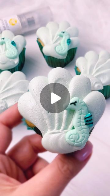 Wilton Cake Decorating on Instagram: "Mermaid summer vibes 🧁🧜‍♀️ Use this baking hack to turn your cupcakes into magical shells. 🐚✨   Here’s how to make them: 🐚Use aluminum foil balls to shape your filled cupcake liners into seashells before baking 🐚Color buttercream frosting in your favorite jewel colors 🐚 Pipe seashell details with tip 2A 🐚Decorate with Silver Edible Glitter Spray and top with a Sea Life Royal Icing Decoration   #WiltonCakes #Cupcakes #TheLittleMermaid #CupcakesOfInstagram #BakingReels #BakingHacks #SummerDesserts #CupcakeDecorating" Mermaid Cupcakes Ideas, Mermaid Cupcake Cake, Edible Glitter Spray, Under The Sea Cupcakes, Baking Hack, How To Decorate Cupcakes, Buttercream Frosting Cookies, Seashell Cupcakes, Shell Cake