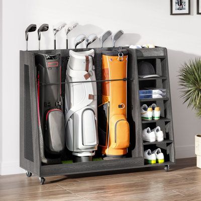 Organize your golf gear with ease using our large-capacity golf organizer. It holds 2 - 3 bags, balls, shoes, and accessories, while securely storing up to 5 clubs (white) or 8 clubs (black). Crafted from premium wood and metal, this rack is perfect for garages, homes, clubs, or basements. With 360° swivel wheels, it's easy to move around, and the included turf mat and elastic strap protect your bags. Ideal for golfers, it measures 35.4" L x 17.7" W x 40.15" H (White) or 47.24" L x 17.7" W x 40. How To Store Chairs In Garage, Sports Storage Room, Golf Bag Holder Diy, Sport Storage Ideas, Golf Organization Garage, Garage Golf Storage, Golf Storage In Garage, Golf Club Storage Garage, Golf Storage Ideas