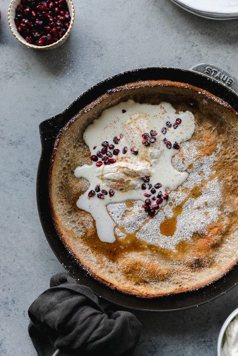 This Chai Dutch Baby with Eggnog Whipped Cream is a super light, fluffy pancake made in a skillet in the oven! It's infused with chai spices and topped with a delicious eggnog whipped cream and fresh pomegranate arils! It's perfect, simple recipe to make for brunch if you're serving a crowd! #dutchbaby #pancake #chai #eggnog #whippedcream #breakfast #brunch Eggnog Whipped Cream, Holiday Brunch Recipes, Sandwich Shapes, Baking Lessons, Chai Spices, Breakfast Platter, Ice Cream Cookie Sandwich, Holiday Brunch, Dutch Baby