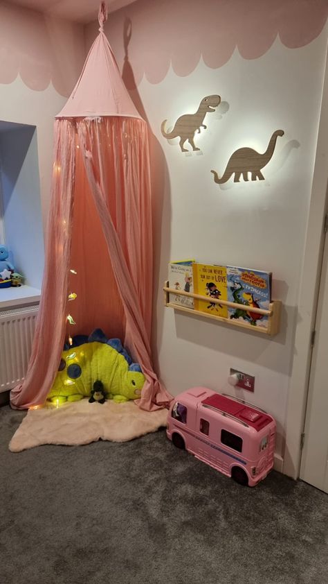 Dinosaur themed room for my little girl - a perfect balance of girly and Dino! Complete with reading ! #dinosaur #toddlerbedroom # pinkbedroom #pinkceiling #lickpaint #scallopededge #roommakeover #girlsbedroomideas Pink Dinosaur Room Decor, Girly Dinosaur Bedroom, Purple Dinosaur Room, Girly Dinosaur Room Decor, Pink Dinosaur Bedroom, Rainbow Dinosaur Room, Girly Dinosaur Room, Dinosaur Bedroom Girl, Pink Dinosaur Room