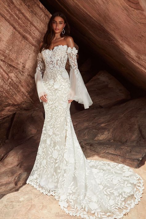 With a sheath silhouette adorned in bold floral lace, there’s no doubt in our minds that this bohemian wedding dress design is going to satisfy the free-spirited brides looking for something different. She is designed with a romantic semi-sweetheart neckline, a trendy back cut-out design that adds a uniquely modern twist, and dramatic, long, off-the-shoulder bell sleeves which adds flair and movement. Embrace Pixie and let boho dreams come to life. Wedding Dress Bell Sleeves, Semi Sweetheart Neckline, Bell Sleeve Wedding Dress, Unique Boho Wedding Dress, Calla Blanche, Nude Gown, Dress Bell Sleeves, Modern Bridal Gowns, Wedding Dress Sketches