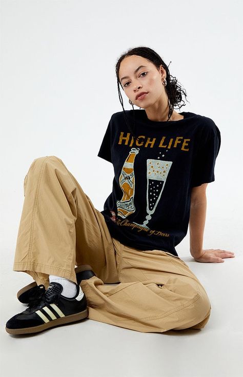 Step up your graphic tee rotation with the new Miller High Life T-Shirt from Junk Food. Crafted for both comfort and style, this tee effortlessly combines retro flair with a touch of casual coolness.Solid color teeShort sleevesCrew necklineFront graphicRelaxed fit100% cottonMachine washableModel is wearing a size smallModel measurements: 5’7.5” height, 32” bust, 23” waist, 35” hip Junk Food Womens Miller High Life T-Shirt - Black size XS Womens Tshirt Outfit, Casual Outfits Tshirt, Vintage Tee Outfit, Black Tshirt Outfit, Graphic Tshirt Outfit, Short Tshirt, Tee Shirt Outfit, Baggy Tee, Miller High Life