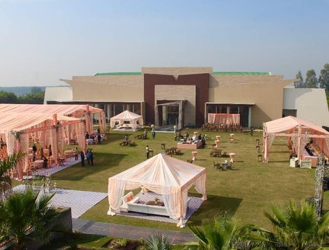 "The banquet hall of Cavanal Hill Resort is one of the wedding venues in Chandigarh where you can celebrate the marriage in the most exquisite manner. The grand bnquet hall of  can host up to 1200 people at once.  THE GOOD LIFE KEEPS GETTING BETTER AT CAVANAL HILLS RESORT. – 65000 SQ. FT. LAWN AREA. – 17000 SQ. FT. AC BANQUET HALL. – 12000 SQ. FT. COVERED KITCHEN AREA. – 25000 SQ. FT. FULLY WATER PROOF OUTDOOR DECOR. – 24×7 SECURITY & POWER BACKUP. – SPACE FOR 400+ CAR PARKING. Open Area Wedding Decoration, Open Lawn Wedding Decoration, Indian Banquet Hall Design Exterior, Marriage Lawn Design, Marriage Hall Design, Small Wedding Hall, Marriage Hall Decoration, Marriage Hall, Lawn Designs