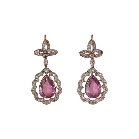 A delicate pair of platinum Edwardian earrings with a little bow set with rose cut diamonds with suspending below a drop shaped pink topaz with rose cut diamonds surround, England, circa 1910. measurements topaz: 1 x 0.7 cm weight: 5.23 grams dimensions: 3 x 1.4 cm Edwardian Jewelry Earrings, Convertible Jewellery, Edwardian Earrings, Pink Topaz Earrings, Pink Diamond Jewelry, 1950s Jewelry, Pink Jewels, Edwardian Jewelry, Platinum Earrings