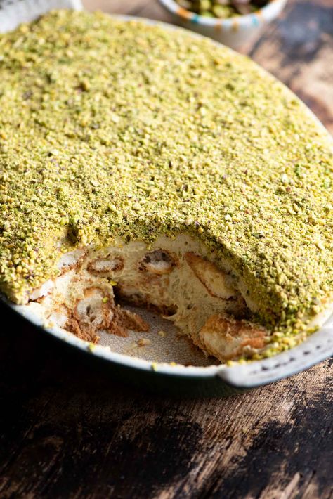 A pistachio tiramisu in an oval dish with a slice missing. Desserts With Pistachios, Italian Pistachio Dessert, Ways To Use Pistachio Cream, Pistachio Creme Recipes, Pistachio Baking, Pistachio Butter Recipe Desserts, Pistachio Butter Uses, Pistachio Cream Recipe, Pistachio Chiffon Cake