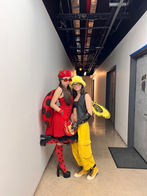 Two girls wearing Halloween costumes one girl is wearing a red polka dot dress red and black knee high polka dot socks black platform Steve Madden heels ladybug wings and a red kangol hat. Other girl is wearing yellow cargo pants yellow converse black bra black leather vest a yellow furry hat and bumble bee wings. Easy Lesbian Couple Halloween Costumes, Ladybug And Bee Costume, Couples Halloween Costume Ideas For Lesbians, Halloween Costumes For Lesbian Couple, Lesbian Couple Costumes For Halloween, Couple Halloween Costumes For Lesbians, Ladybug Costume Diy, Girl Couple Costumes, Gay Halloween Costumes Women