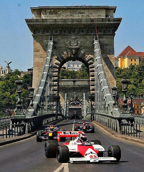 2019 Hungarian GP ~ F1 cars on the chain bridge in Budapest is part of the magic of the Hungarian Grand Prix! Scuderia Toro Rosso, Red Bull Racing, and a classic McLaren MP4 F1 car having fun on the chain bridge before the 2011 Hungarian GP. #F1 #Formula1 #HungarianGP #Budapest #ChainBridge #RedBullRacing #McLarenMP4 Formula 1 Landscape Wallpaper, Formula 1 Gp, Ferrari Formula 1 Wallpaper Pc, Ferrari F1 Desktop Wallpaper Hd, Spanish Gp F1, F1 Wallpapers, F1 Pictures, Hungarian Grand Prix, Hungarian Grand Prix Formula One