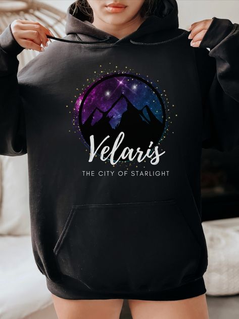 If you're a fan of the ACOTAR series by Sarah J. Maas, this ACOTAR Velaris Night Court Black Hoodie is a must-have addition to your wardrobe! This black hoodie features the iconic imagery of the Night Court, making it the perfect wearable bat boys merch. Velaris The City Of Starlight, The City Of Starlight, Acotar Aesthetic, Acotar Velaris, Velaris City Of Starlight, Court Of Mist And Fury, City Of Starlight, Roses Book, Book Merch