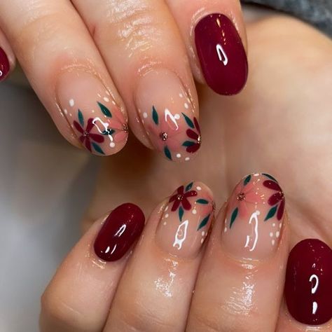 It can be anything, as long as it's holiday-themed! Cute Short Acrylic Nails Burgandy, Winter Floral Nail Art, Burgundy Flower Nail Designs, Burgundy Nails Flowers, Burgundy Nails With Flowers, Maroon Floral Nails, Fall Nail Flower Designs, Dark Red Flower Nails, Burgundy Floral Nails