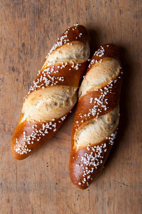 There are many stories of where pretzels and pretzel bread sticks came from. One Swabian story, which supposedly goes back to 1477, tell of a master baker Frieder, who not only invented the pretzel bread stick out of necessity, but that a cat jumped on the baking sheet as he was baking and caused dough Savoury Loaf, Buns And Braids, Tailgate Treats, Bavarian Pretzel, Bread Stick, Pretzel Bread, Pretzel Dough, German Bread, Bread Sticks Recipe