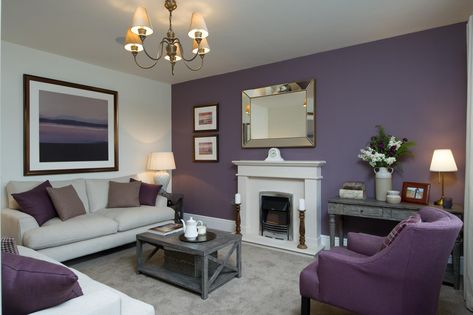 This living room has a colour scheme of beautiful heather tones which carries through from the feature wall to the statement chair and artwork. This is perfectly complemented by deep aubergine accessories. Plum Living Room Ideas, Lilac Living Rooms, Purple And Grey Living Room, Plum Living Room, Violet Living Room, Lilac Living Room, Mauve Living Room, Purple Living Room Ideas, Purple Living Room