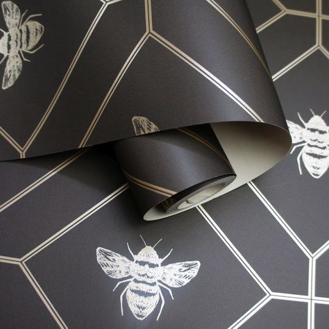 A contemporary design featuring a linear bumble bee motif amongst a delicate trellis design featuring a vibrant metallic effect. Seen here in the Charcoal Shiny colourway. Shiny Wallpaper, Honeycomb Wallpaper, Bee Wallpaper, Hanging Wallpaper, Charcoal Paper, Feature Wallpaper, Black And White Theme, Trellis Design, Glass Splashback