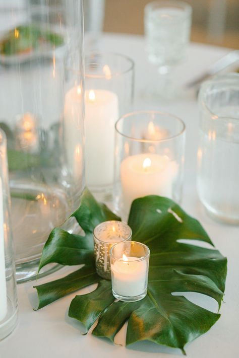 Tropical Candle Centerpieces Wedding, Tropical Diy Centerpieces, Elegant Tropical Party Decor, Tropical Leaves Centerpiece, Tropical Rehearsal Dinner Decorations, Tropical Engagement Party Ideas, Cheap Tropical Centerpieces, Old Florida Party Theme, Tropical Leaf Centerpiece