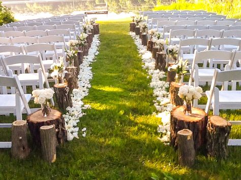 Rustic Outdoor Ceremony Decor, Stump Decorating Ideas Wedding, Fall Wedding Aisle Decorations Outdoor Tree Stumps, Wedding Arch With Tree Stumps, Wood Stump Wedding Aisle, Log Aisle Decor Tree Stumps, Tree Stumps Wedding Aisle, Wood Isle Wedding, Beginning Of Isle Wedding Decor