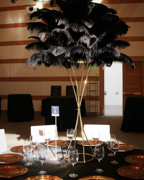 Can’t get over how stunning our black ostrich feather centerpiece looks in this dramatic lighting 🤩😍 • • • #ostrichfeathers #ostrichfeathercenterpieces #tablecenterpiece #feathercenterpieces #weddinginspiration #weddingtablesetting #greatgatsbyparty #greatgatsbytheme #greatgatsbywedding #greatgatsbydecor #tablesetting #tablescapes #oldhollywoodglamour Black And Gold Centerpieces, Gatsby Decor, Ostrich Feather Centerpieces, Great Gatsby Theme, Feather Centerpieces, Gold Centerpieces, Great Gatsby Wedding, Great Gatsby Party, Dramatic Lighting