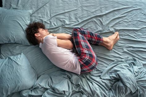 Top view stressed unhappy young man lying in fetal position on bed alone, upset guy suffering from stomach ache or royalty free stock photography Lying Down Pose Reference Top View, Fetal Position Drawing Reference, Bed Top View, Kids Lying, Fetal Position, Men Lie, Stomach Ache, Sleeping In Bed, Vector Map