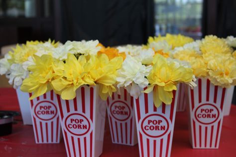 Table centerpieces, made from dollar store popcorn containers and flowers. Hollywood Graduation, Circus Party Foods, Popcorn Containers, Vintage Circus Party, Popcorn Tin, Staff Meeting, Fancy Stuff, White Flower Arrangements, Prom 2022