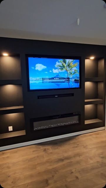 Modern Accent Wall on Instagram: "This Media Center wall deserves an ENCORE 👏🏼✨! #ModernAccentWalls #LuxuryCustomWalls #TricornBlack #LivingRoomGoals #familyRoom #MediaCenter" Black Accent Wall With Fireplace And Tv, Entertainment Wall Ideas Living Room, Black Wall Behind Tv, Accent Wall Behind Tv, Wallpaper Tv Wall, Built In Tv Wall Unit, Modern Accent Wall, Wall Behind Tv, Brown Accent Wall