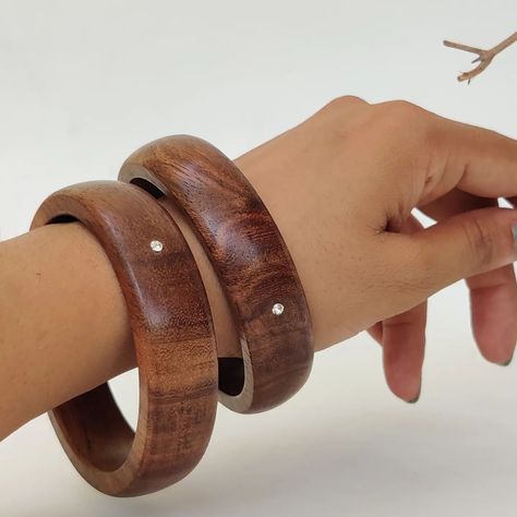 "EcoWood Bangles " . Each wooden bangle is meticulously handcrafted, showcasing the fusion of natural materials and subtle elegance. The base material—rosewood—brings warmth, texture, and an earthy vibe to the design. . zirconia adds a touch of sophistication. . The smooth, polished surface feels comfortable against the skin, making these bangles perfect for everyday wear. . Size - 2.4 & 2.8 available . #customisationavailable For custom order Dm or WhatsApp me at 7304854836. THANK you . . .... Wooden Jewellery, Wooden Bangle, Subtle Elegance, Wooden Jewelry, Natural Materials, Everyday Wear, Bangles, Size 2, Texture